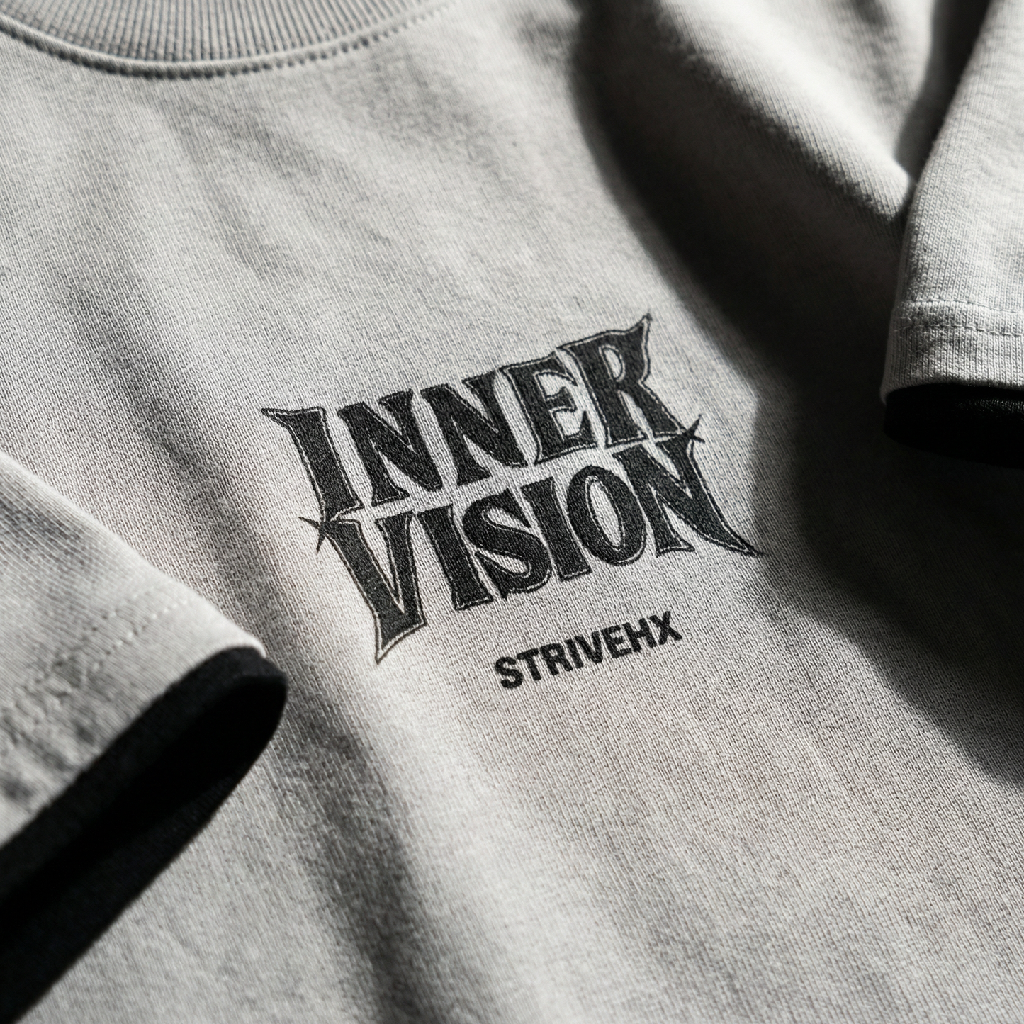 Macro detail of typographic print on Gray cotton tee.