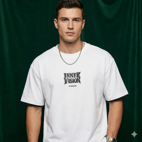Man wearing WEARON Inner Vision Tee in White with chest typographic print, deep green velvet backdrop, full body.