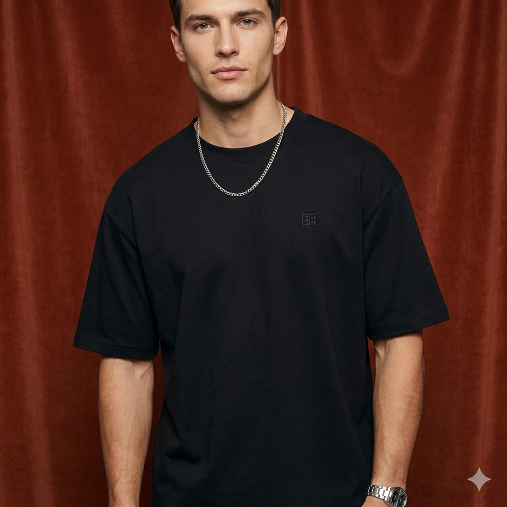 Close-up of WEARON Logo Patch Tee in Black on model, rust velvet backdrop.