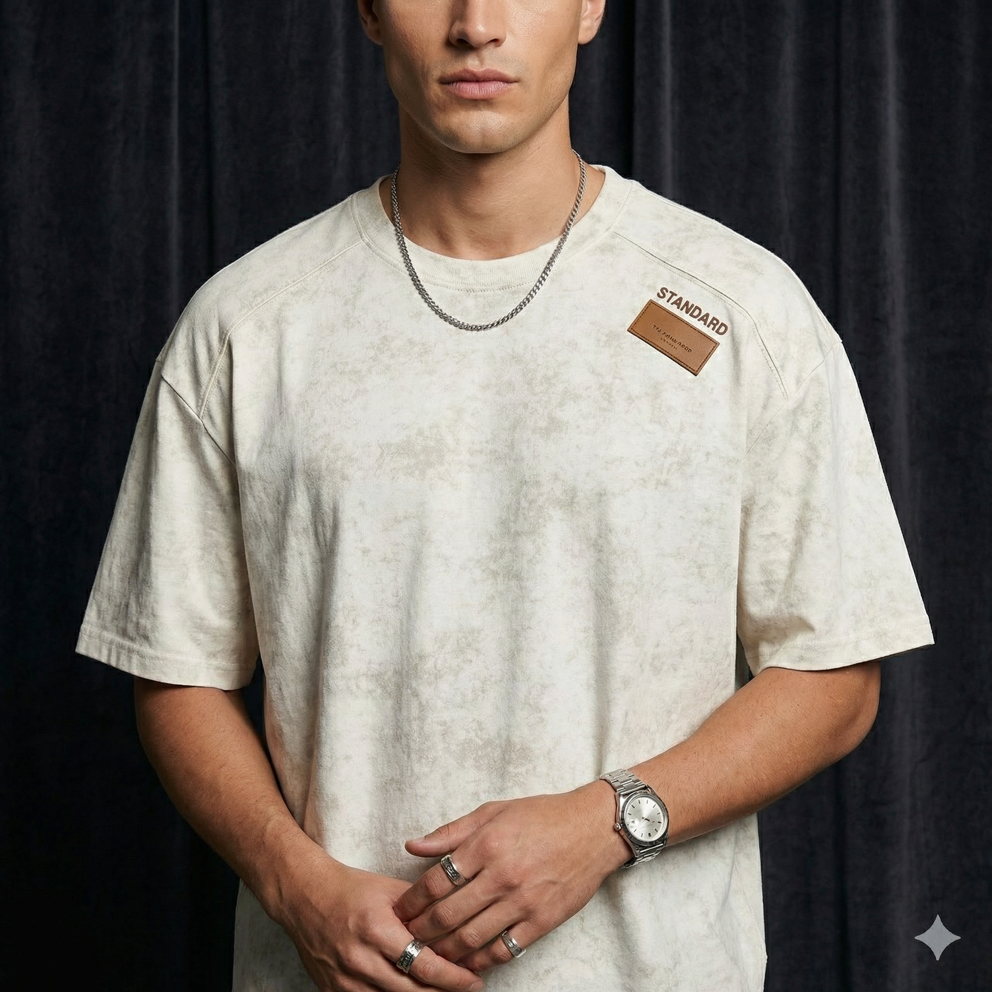 Close-up of WEARON Acid-Wash Patch Tee in Blue showing stitched leather shoulder patch and acid-wash texture.