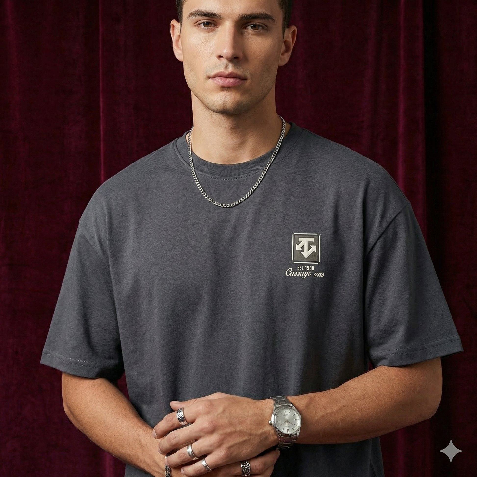 Close-up of WEARON Heritage Crest Tee in Gray with chest crest print, burgundy velvet backdrop.