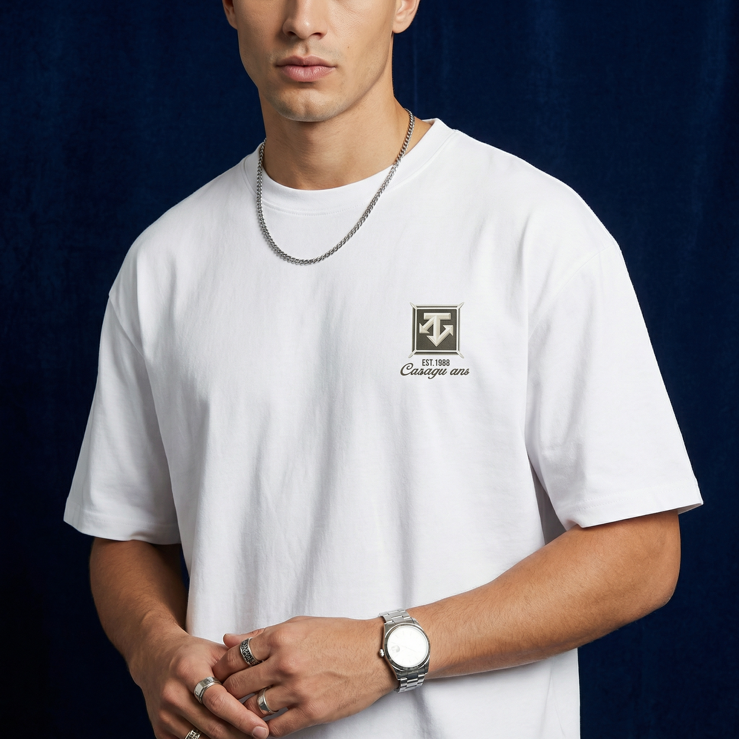 Close-up of WEARON Heritage Crest Tee in White with chest crest print, navy backdrop.
