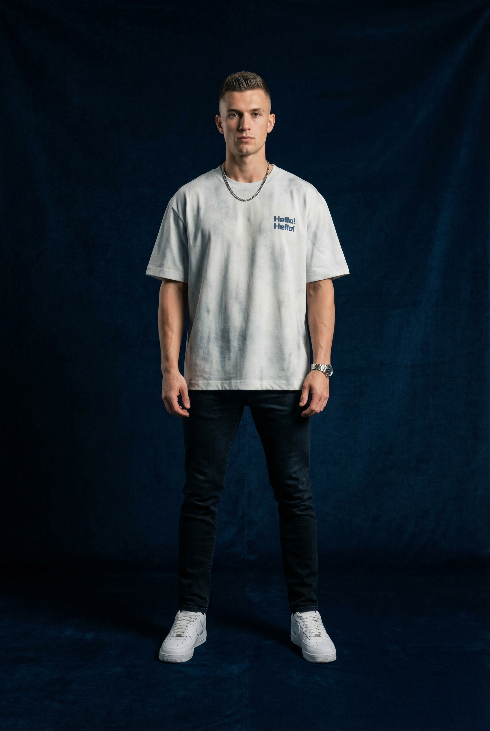 Man wearing WEARON Hello Tee in Light Gray acid-wash, full body, navy backdrop.