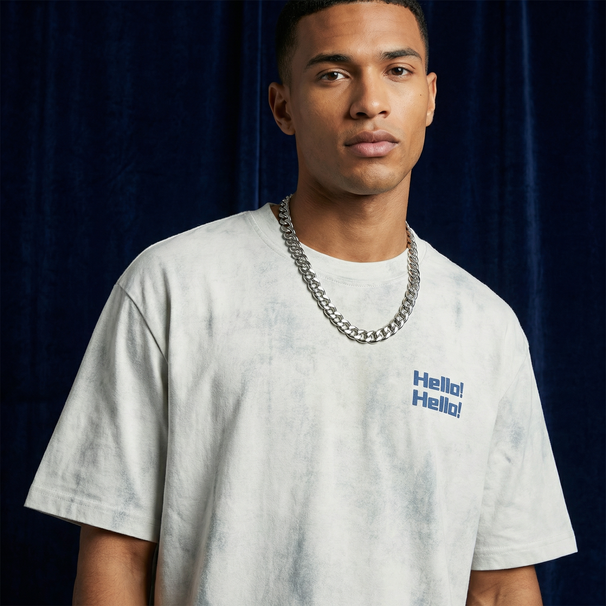Close-up of WEARON Hello Tee in Light Gray acid-wash showing chest 'Hello! Hello!' print, navy backdrop.
