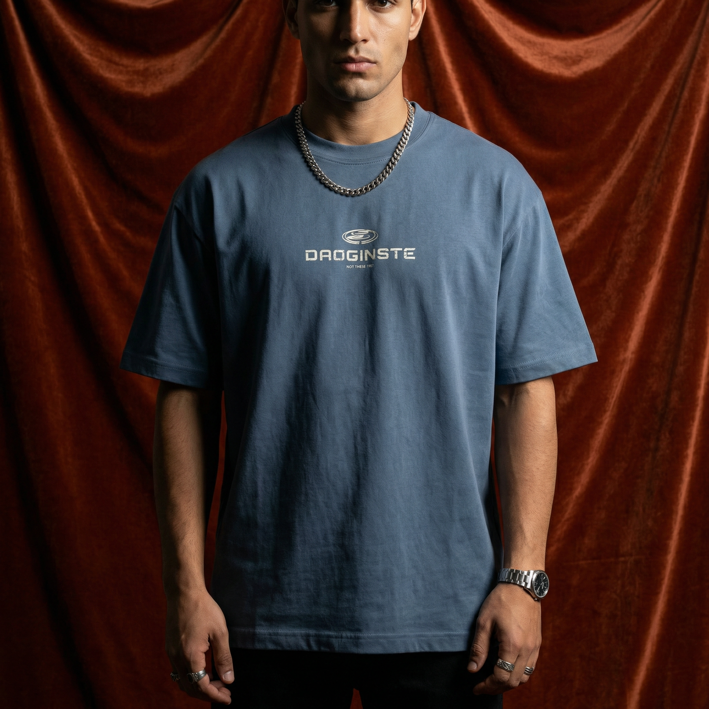 Man wearing WEARON Sport Logo Tee in Slate Blue, full body, rust velvet backdrop.