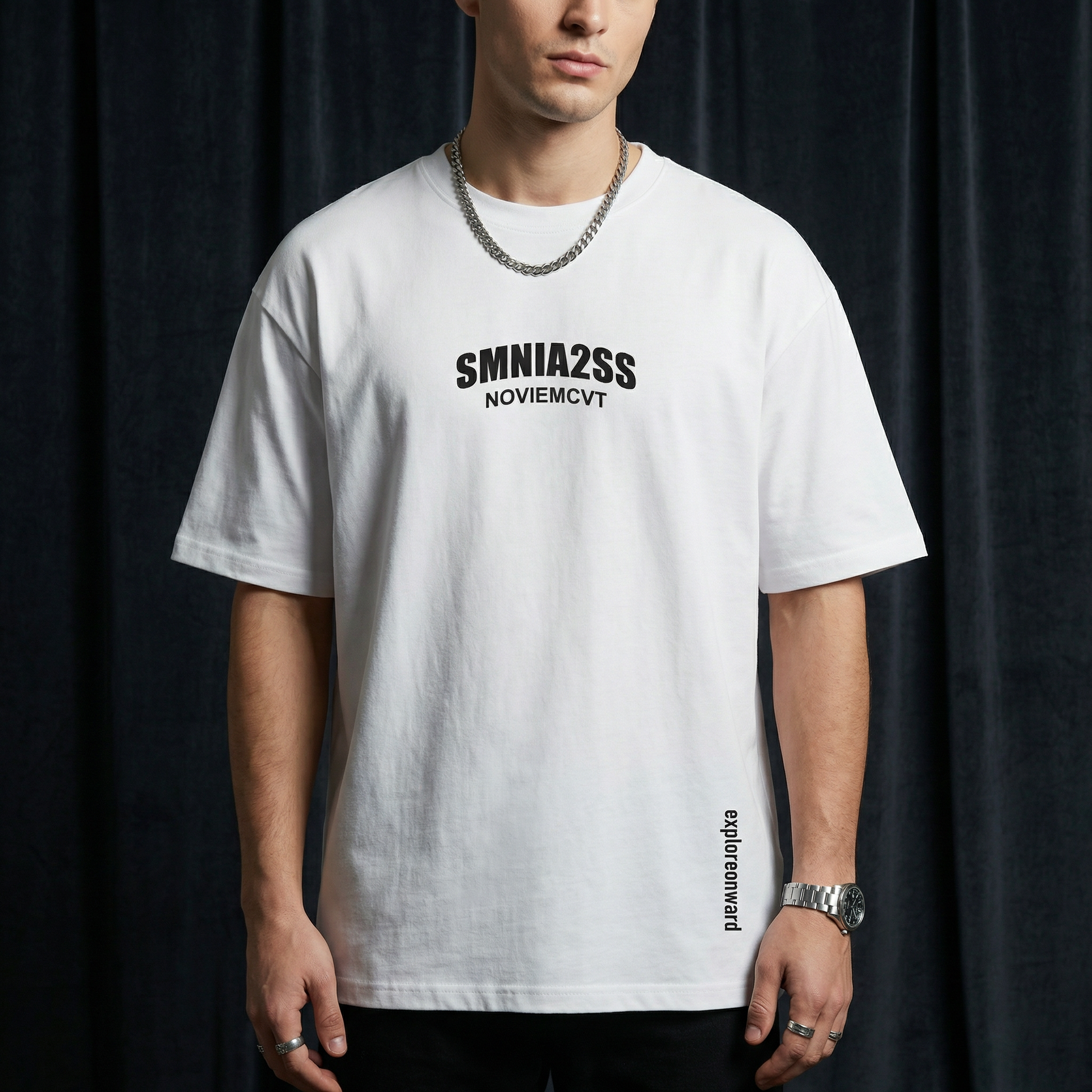 Close-up of WEARON Explore Onward Tee in Black with chest typographic print, rust velvet backdrop.