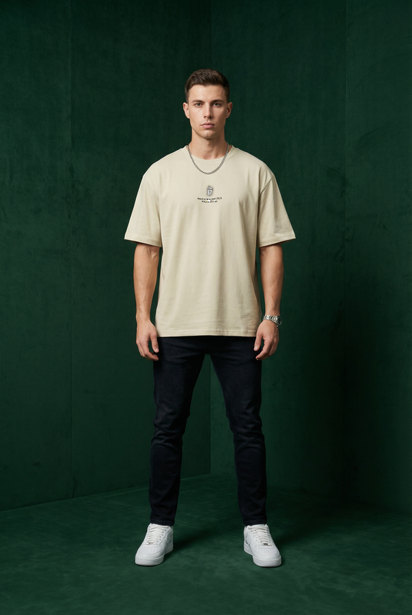 Man wearing WEARON Coffee Cup Tee in Beige, full body, deep green velvet backdrop.
