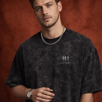Close-up of WEARON Mineral-Wash Tee in Black with mineral-wash effect, rust velvet backdrop.