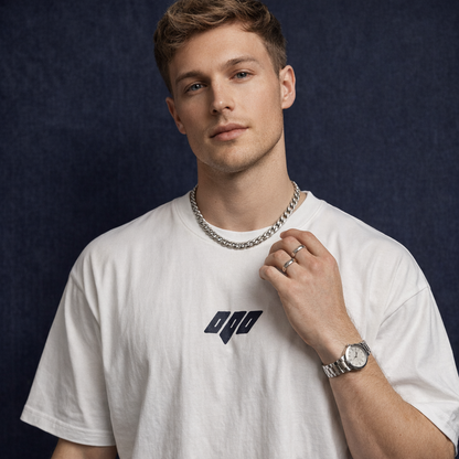 Man wearing WEARON Geometric Logo Tee in Brown with chest geometric emblem, deep blue velvet backdrop, full body.