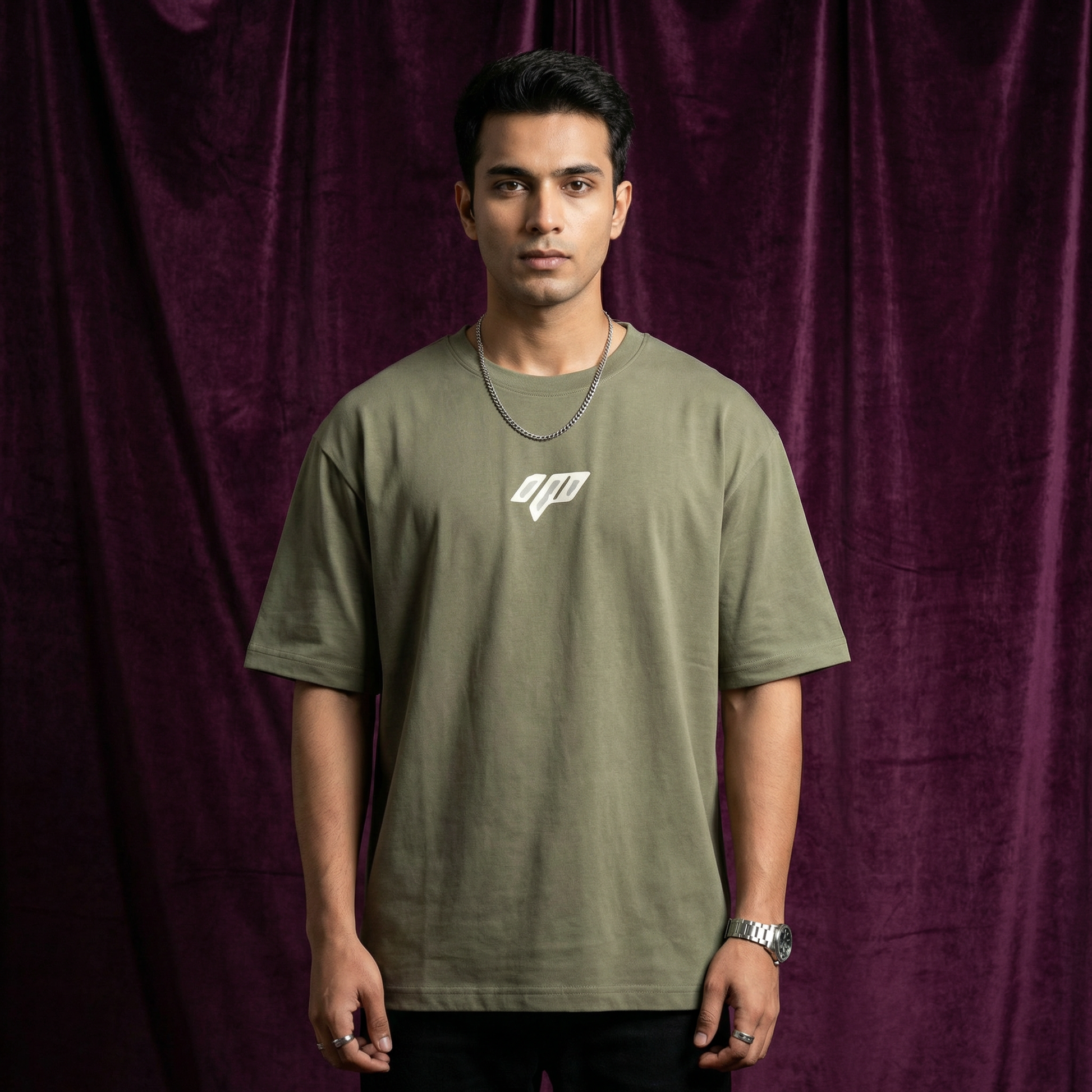 Full body view of WEARON Geometric Logo Tee in Olive, deep purple velvet backdrop.