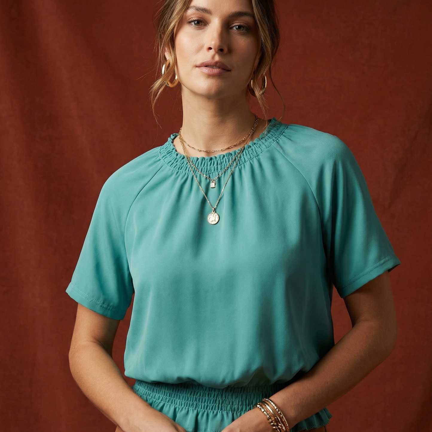 Close-up of WEARON Smocked Satin Top in Teal showing smocked neckline detail and silk-touch satin finish.