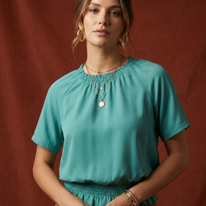 Close-up of WEARON Smocked Satin Top in Teal showing smocked neckline detail and silk-touch satin finish.