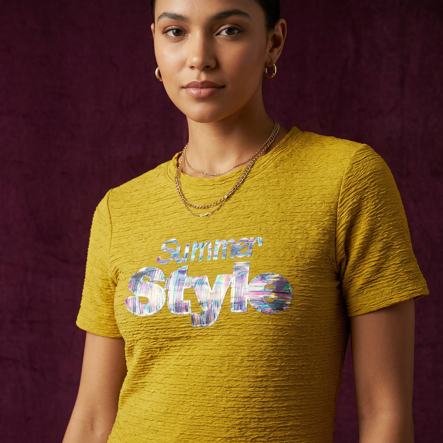 Close-up of WEARON Iridescent Slogan Mini Dress in Mustard featuring the iridescent Summer Style graphic, deep purple velvet backdrop.