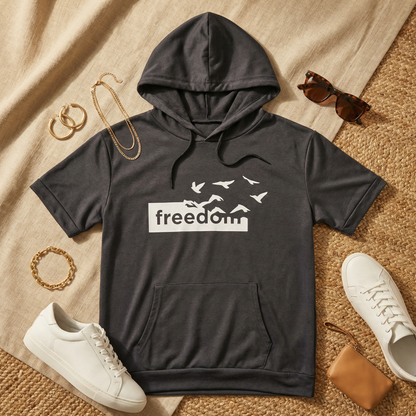 Flat lay of WEARON Short-Sleeve Hoodie Tee in Charcoal styled with white sneakers, tortoiseshell sunglasses, gold jewellery.