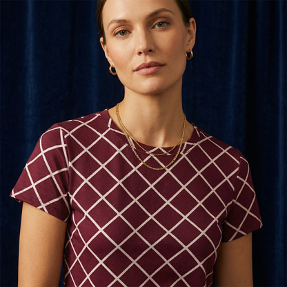 Close-up of WEARON Diamond Lattice Tee in Burgundy with cream bias-set windowpane lattice print, navy velvet backdrop.
