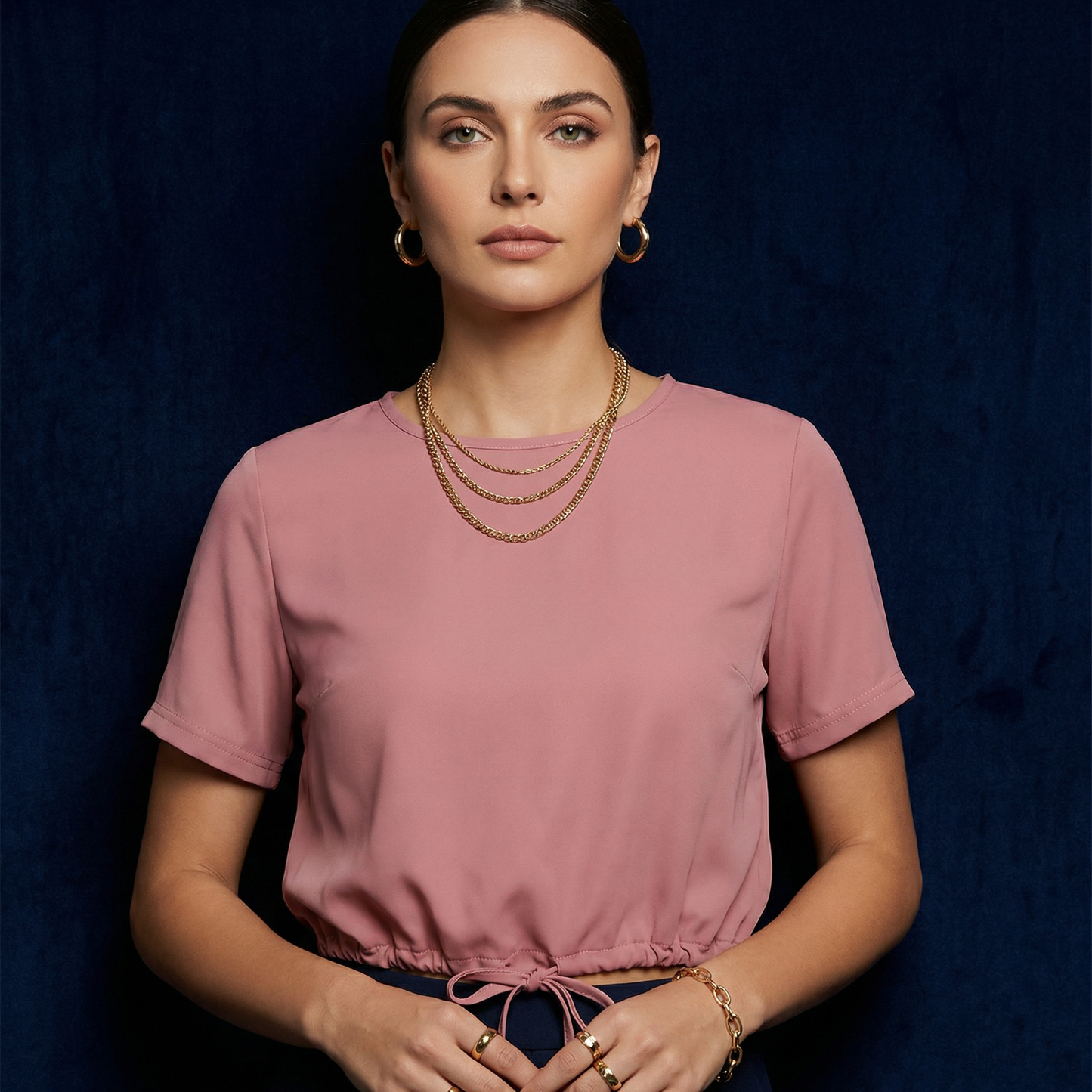 Close-up of WEARON Drawstring-Hem Top in Pink with self-drawstring hem, navy velvet backdrop.