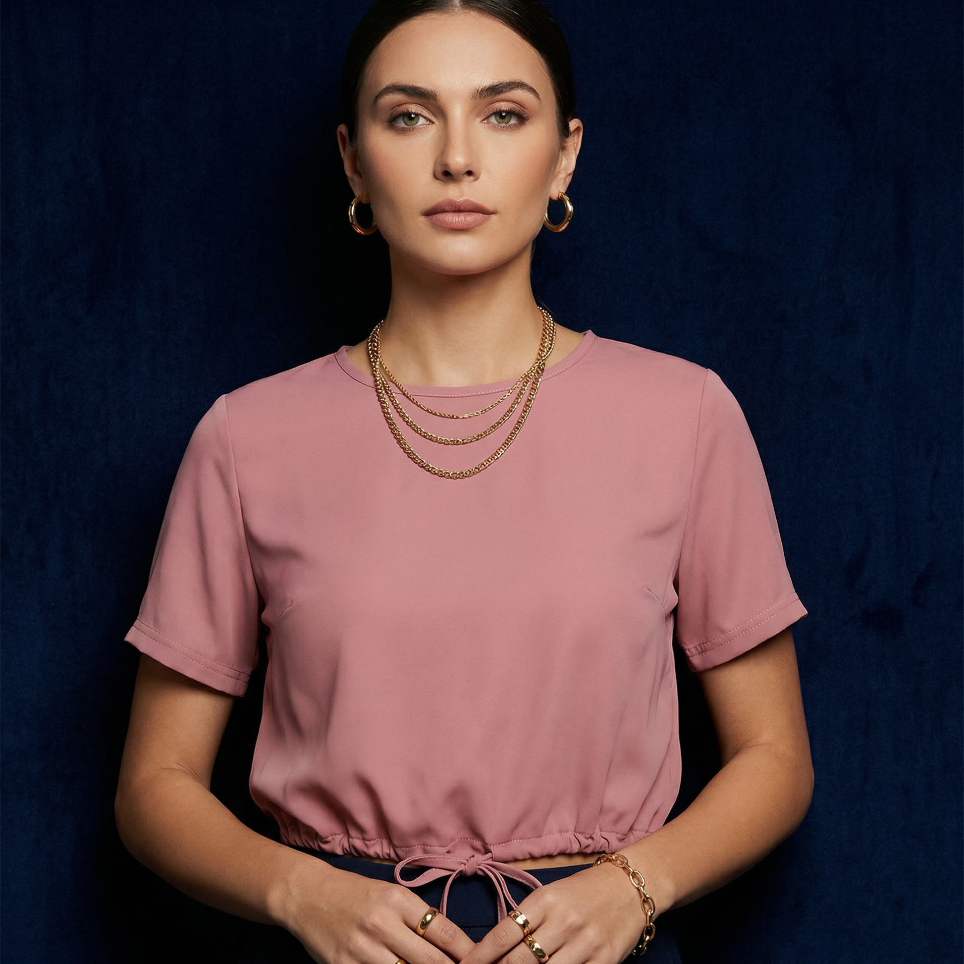 Close-up of WEARON Drawstring-Hem Top in Pink with self-drawstring hem, navy velvet backdrop.